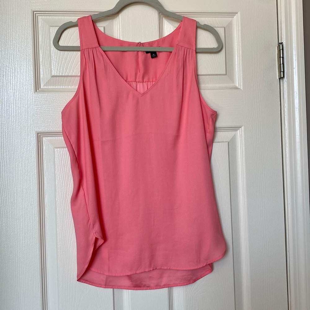 Soft peachy pink blouse.